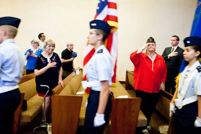 Alice Fleckenstein, center left, and Navy veteran the Rev. Marie Tombow pay honor as the Las Vegas Composite Squadron Color Guard of the Civil Air Patrol retire the colors during the 48th Annual Memorial Day Service at the Palm Downtown Mortuary and Cemetery in Las Vegas, Monday, May 27, 2013.